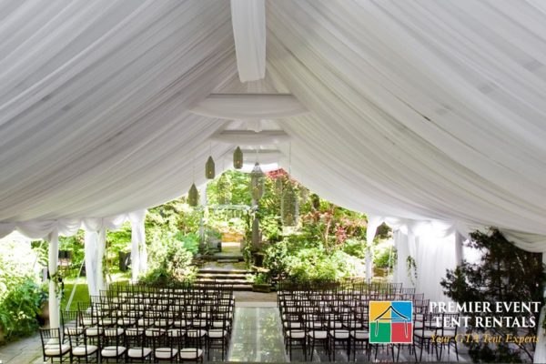 Interior Ceremony set up with ceiling liner and pole drapes-min