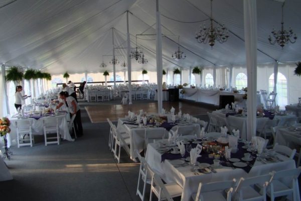 Pole-Tent-Interior-with-chandeliers-pole-drapes-and-wood-grain-dance-floor-min