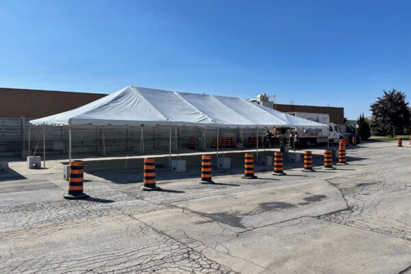 30’x60’ Frame Tent with a solid white roof, no walls in a parking lot for a corporate BBQ in Mississauga.