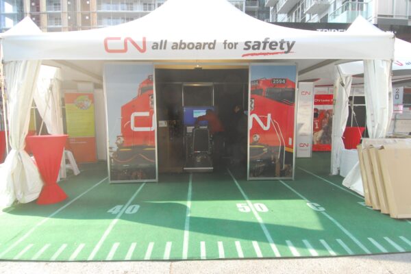 20’x20’ Solara High Peak Tent for CN Rail with a custom logo and walls tied open for a temporary corporate activation space.
