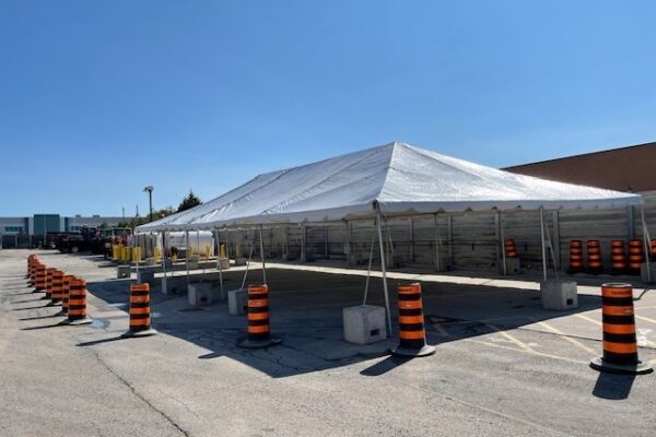 30’x60’ Frame Tent with a solid white roof, no walls in a parking lot for a corporate BBQ in Mississauga.